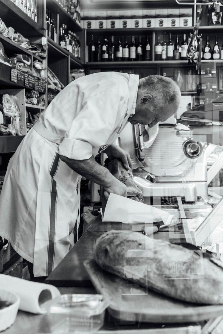 A look Inside an italian butchery in Rome Italy. Notice the reflection of the famous monuments in the right bottom corner.
